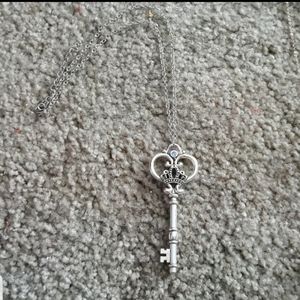 Skeleton key charm with adjustable chain.